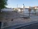 Front yard view behind a chain link fence with the partial side of a home at 2645 Cedar Ave, Las Vegas, NV 89101