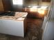Damaged kitchen features outdated countertops and cabinetry. A restoration project ready for remodeling at 2645 Cedar Ave, Las Vegas, NV 89101