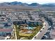 Expansive aerial view showcases the community's pool, playground, and lush landscaping against a mountain backdrop at 2722 Marchetti Pl, Henderson, NV 89044