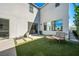 Inviting backyard features a modern patio with seating, artificial grass, and lush greenery at 2722 Marchetti Pl, Henderson, NV 89044