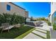 Inviting backyard features a modern hot tub, artificial grass, and a stylish seating area at 2722 Marchetti Pl, Henderson, NV 89044