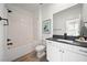 Modern bathroom features a shower-tub combo, large mirror, and contemporary fixtures at 2722 Marchetti Pl, Henderson, NV 89044
