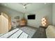 Inviting bedroom with contemporary decor, a ceiling fan, and a comfortable seating area at 2722 Marchetti Pl, Henderson, NV 89044