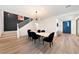Elegant dining room with modern lighting, sleek furniture, and a view of the staircase at 2722 Marchetti Pl, Henderson, NV 89044