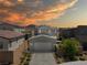 A modern home with well-maintained landscaping and great curb appeal at sunset at 2722 Marchetti Pl, Henderson, NV 89044