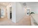 Bright hallway with minimalist white walls, neutral carpet, and access to laundry room and bedrooms at 2722 Marchetti Pl, Henderson, NV 89044