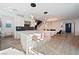 Bright, open-concept kitchen featuring a large island with marble countertop, pendant lights, and stainless steel appliances at 2722 Marchetti Pl, Henderson, NV 89044