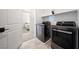 Convenient laundry room featuring modern appliances and adjacent bedroom access at 2722 Marchetti Pl, Henderson, NV 89044