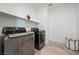Modern laundry room with new washer, dryer, and ample shelving at 2722 Marchetti Pl, Henderson, NV 89044