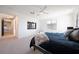 Spacious main bedroom with contemporary design, a ceiling fan, large windows, and access to other rooms at 2722 Marchetti Pl, Henderson, NV 89044