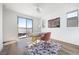 Bright home office with wood-look flooring, access to a terrace, minimalist desk and decor at 2722 Marchetti Pl, Henderson, NV 89044