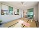 Bright yoga room features tatami mats, large windows, and a modern ceiling fan at 2722 Marchetti Pl, Henderson, NV 89044