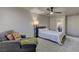 Cozy bedroom featuring a soft gray chaise lounge and ensuite bathroom at 278 Star Cluster Cir, Las Vegas, NV 89145