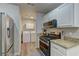 Well-appointed kitchen featuring white cabinets, granite counters, and stainless steel appliances at 278 Star Cluster Cir, Las Vegas, NV 89145