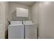 Bright laundry room featuring a stacked washer and dryer with ample storage at 278 Star Cluster Cir, Las Vegas, NV 89145