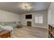Spacious living room with wood-look flooring, fireplace and large windows, perfect for entertaining at 278 Star Cluster Cir, Las Vegas, NV 89145