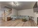 Spacious living room with wood-look flooring and a comfortable sofa with a staircase at 278 Star Cluster Cir, Las Vegas, NV 89145