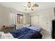 A cozy bedroom offers ample natural light from the window and a ceiling fan at 2851 S Valley View Blvd # 1071, Las Vegas, NV 89102