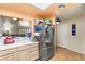 Bright kitchen featuring stainless steel refrigerator, tile flooring and a view of the living area at 2851 S Valley View Blvd # 1071, Las Vegas, NV 89102