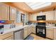 Functional kitchen featuring wooden cabinets, stainless steel appliances, and a black gas range at 2851 S Valley View Blvd # 1071, Las Vegas, NV 89102