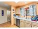 Kitchen sink area features stainless steel dishwasher, window, and storage at 2851 S Valley View Blvd # 1071, Las Vegas, NV 89102