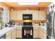 Well-lit kitchen with white cabinets and black appliances, including a gas range and microwave at 2851 S Valley View Blvd # 1071, Las Vegas, NV 89102