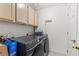Efficient laundry room features overhead storage cabinets and modern washer/dryer at 2851 S Valley View Blvd # 1071, Las Vegas, NV 89102