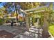 Outdoor kitchen area with a grill, seating, and a pergola covered in climbing plants at 2851 S Valley View Blvd # 1071, Las Vegas, NV 89102