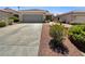 Single-story home with well-maintained landscaping and a two-car garage and driveway at 3053 Monroe Park Rd, Henderson, NV 89052