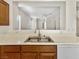 Stainless steel sink and white countertops in the kitchen with wood cabinets at 3053 Monroe Park Rd, Henderson, NV 89052