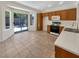 Eat-in kitchen featuring tile floors, white countertops, and backyard access at 3053 Monroe Park Rd, Henderson, NV 89052