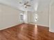Spacious room with hardwood flooring, ceiling fan, and ample natural light from the windows at 3053 Monroe Park Rd, Henderson, NV 89052