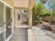 Covered patio provides shade and access to the landscaped backyard with mature trees and greenery at 3053 Monroe Park Rd, Henderson, NV 89052