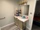 Well-lit bathroom with a vanity that offers storage and a large mirror at 3447 One Nation Ave, Las Vegas, NV 89121