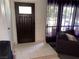 Inviting entryway featuring tile flooring, a stylish front door, and a glimpse of the living area at 3447 One Nation Ave, Las Vegas, NV 89121
