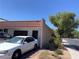 Side exterior view showcasing the red-tiled roof, brick wall, and convenient two-car garage access at 3447 One Nation Ave, Las Vegas, NV 89121