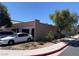 View of the side exterior, showing the brick wall, clay tile roof, and access to the two car garage at 3447 One Nation Ave, Las Vegas, NV 89121