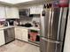 Updated kitchen with stainless steel appliances and white cabinetry for a modern look at 3447 One Nation Ave, Las Vegas, NV 89121