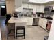 Bright kitchen features white cabinetry, marble countertops, stainless steel appliances, and tile flooring at 3447 One Nation Ave, Las Vegas, NV 89121