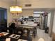 Open concept kitchen with marble counters, stainless steel appliances, and seating at the breakfast bar at 3447 One Nation Ave, Las Vegas, NV 89121