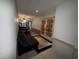 A small living room area adjacent to the kitchen, and featuring double doors to the outside at 3447 One Nation Ave, Las Vegas, NV 89121
