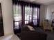 Cozy living room with large windows, sheer curtains, and comfortable seating for relaxing at home at 3447 One Nation Ave, Las Vegas, NV 89121