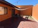 Outdoor patio with dining table, chairs, and shade canopy for relaxation and entertaining at 3447 One Nation Ave, Las Vegas, NV 89121