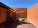 Desert patio with string lights, shade covering and lounge seating at 3447 One Nation Ave, Las Vegas, NV 89121