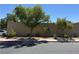 Exterior shot of block wall with lush landscaping and mature trees on a clear day at 3447 One Nation Ave, Las Vegas, NV 89121