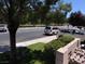 Street view of the home with parking spaces available and landscaped grounds at 3447 One Nation Ave, Las Vegas, NV 89121