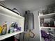 Close-up of utility closet with a tankless water heater and shelving with personal items at 3447 One Nation Ave, Las Vegas, NV 89121