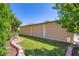 Lush backyard with manicured lawn and a covered patio area for outdoor relaxation at 3557 Wayne Cir, Las Vegas, NV 89121