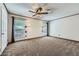 Bedroom with neutral carpet, a ceiling fan, and natural light from two large windows at 3557 Wayne Cir, Las Vegas, NV 89121
