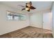 Bedroom features a window with blinds, carpet flooring, and a ceiling fan at 3557 Wayne Cir, Las Vegas, NV 89121